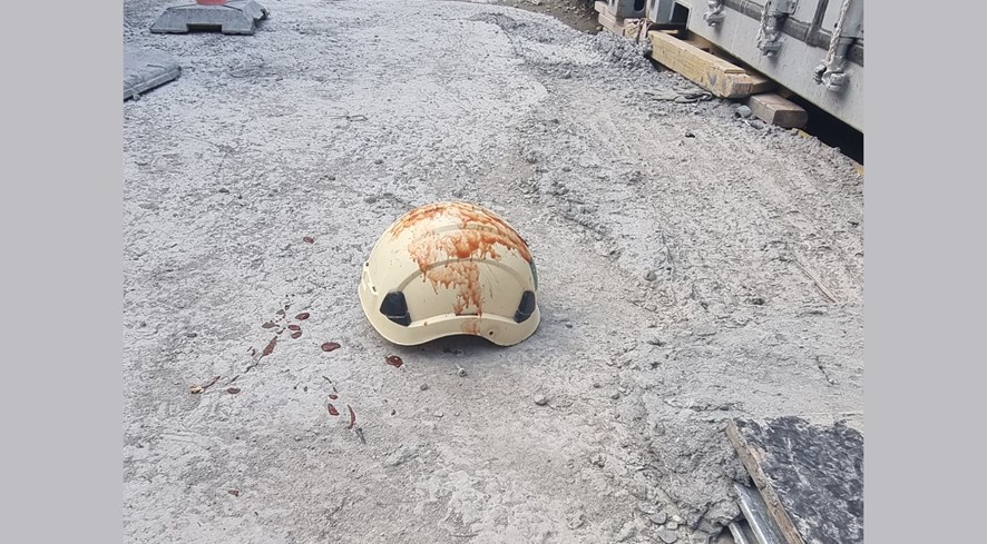 Employees accuse large construction company of hiding work accidents. Foto shows a the bloody helmet of a worker.